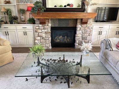 gLASS AND ORNAMENTAL IRON COFFEE TABLE.