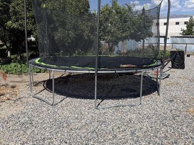 Outdoor Round Trampoline with Safety Enclosure Net and Green Accents