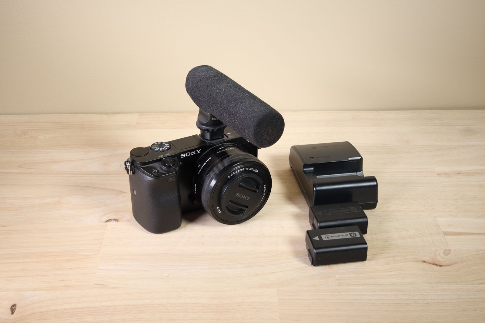 Sony Alpha A6000 APS-C 24.3MP 1080P camera w/ 16-50mm zoom lens, mic, 2 batteries, charger