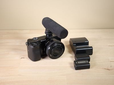 Sony Alpha A6000 APS-C 24.3MP 1080P camera w/ 16-50mm zoom lens, mic, 2 batteries, charger