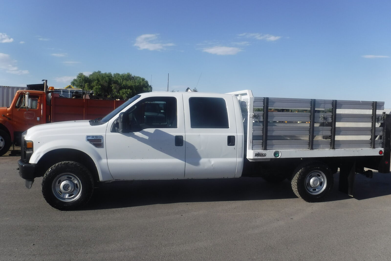 2010 Ford F350 crew cab 4X4 with 9 ft. flatbed and liftgate New Ford crate engine.