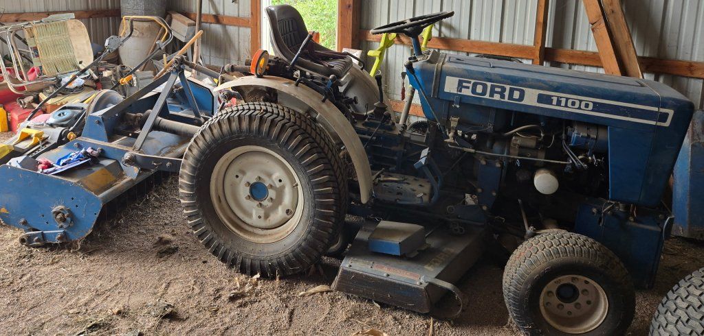 1980 Ford 1100 tractor with 8 attachments.