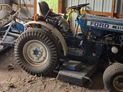 1980 Ford 1100 tractor with 8 attachments.
