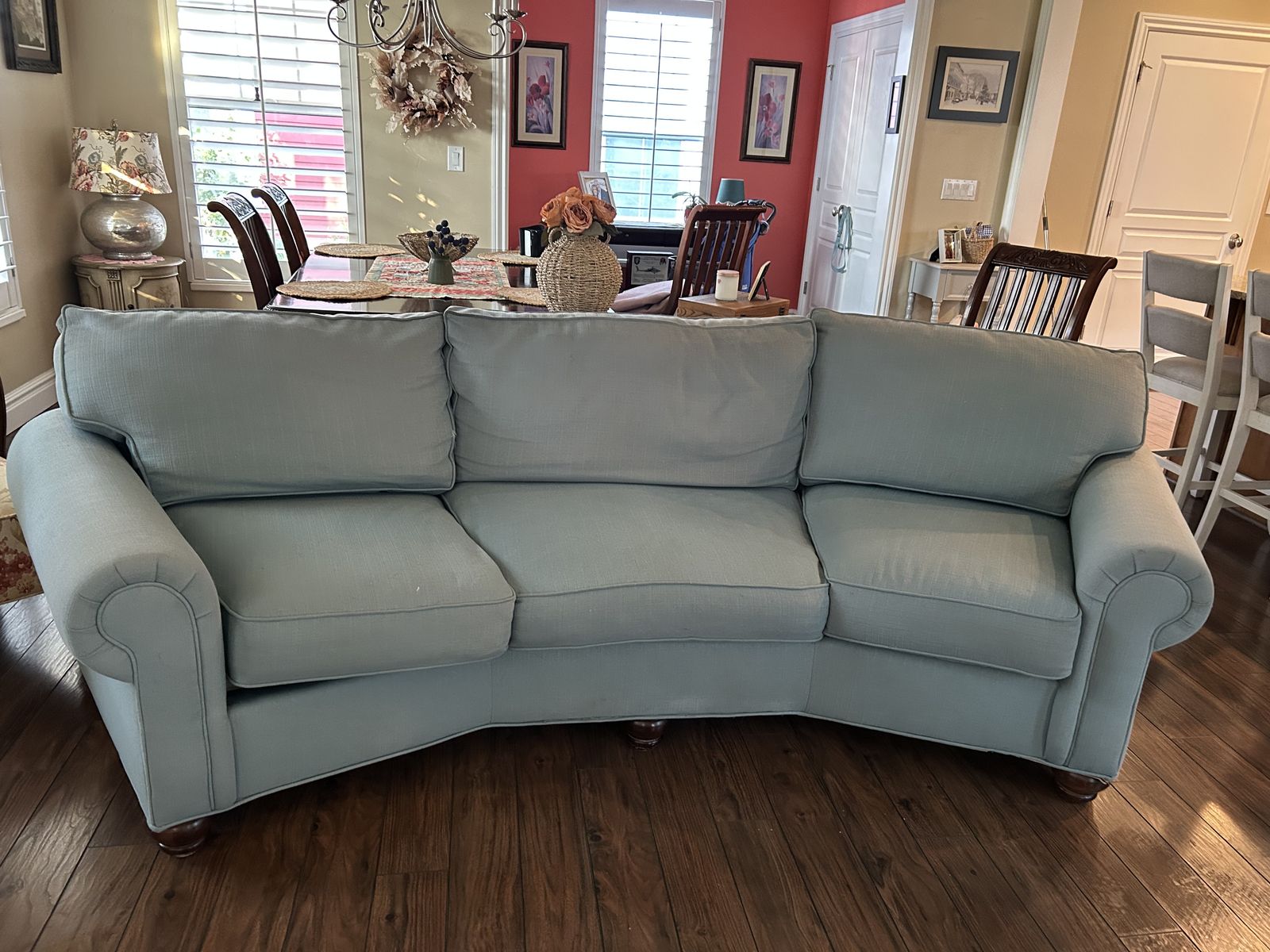 Light Blue Curved Fabric Sofa with Rolled Arms and Wooden Feet