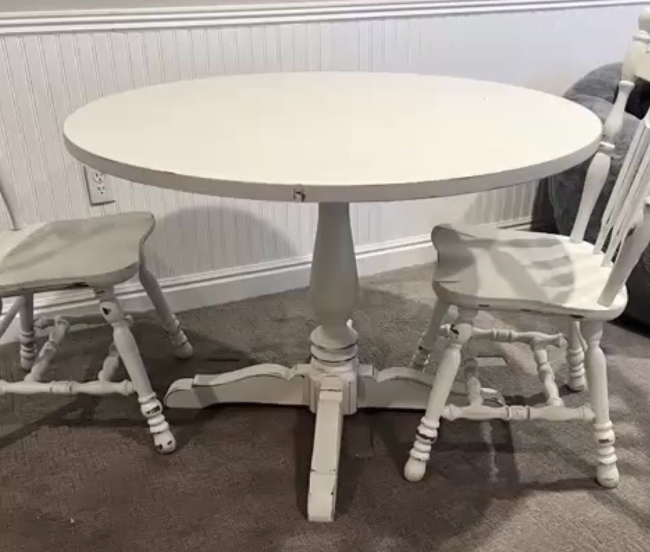 Round dining table with four matching chairs