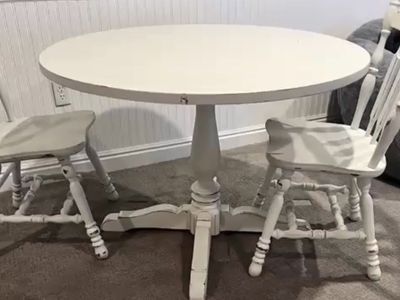 Round dining table with four matching chairs