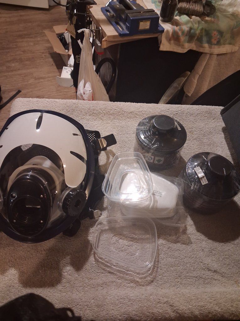 multifunctional full-face respirator mask alongside its filtration components
