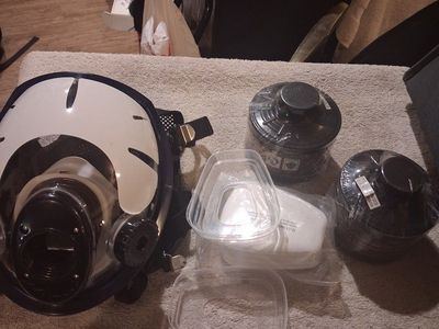 multifunctional full-face respirator mask alongside its filtration components