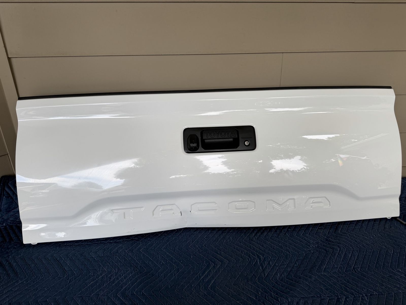 2016-2023 Toyota Tacoma complete tailgate assembly with minor damage.