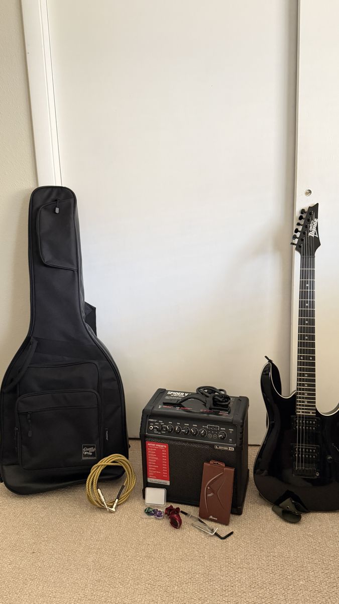 Ibanez CRGA 120BKN Gio Electric Guitar with Amplifier with cable, shoulder strap, carrying Bag, tuner, capo, and set of picks.