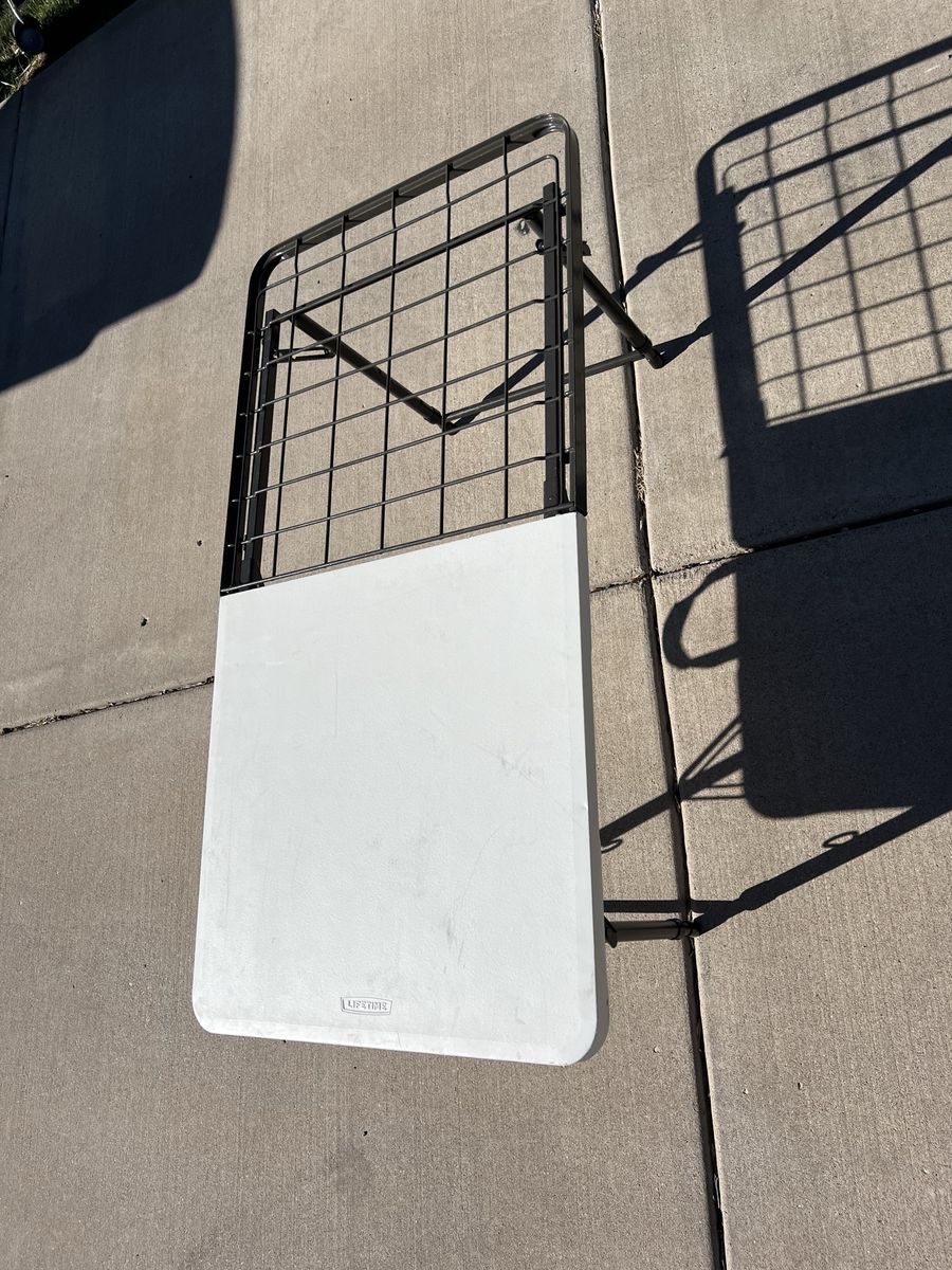 Folding table with metal grid surface