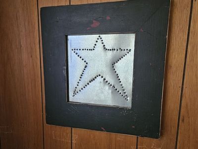 Black wood frame with a hammered metal star