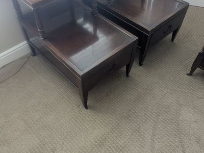 Vintage tables featuring mahogany dark wood frames and brown leather tops with gold inlay.