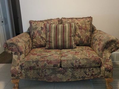Floral Fabric Loveseat Sofa with Carved Wood Feet and Throw Pillow
