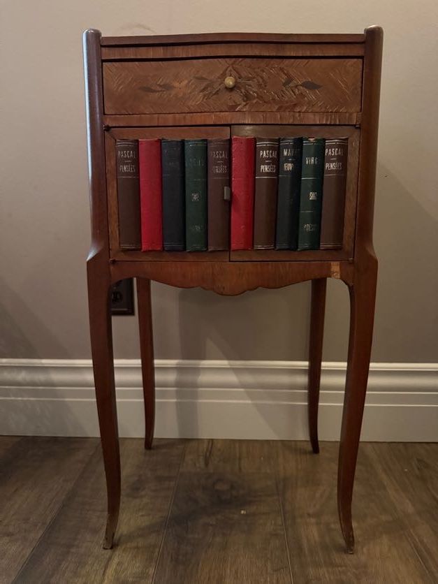 Small accent table with book engraved doors