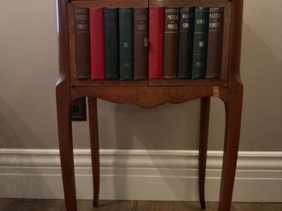 Small accent table with book engraved doors
