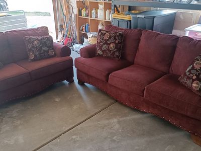 Red Sofa and Loveseat Set with Nailhead Trim and Floral Accent Pillows