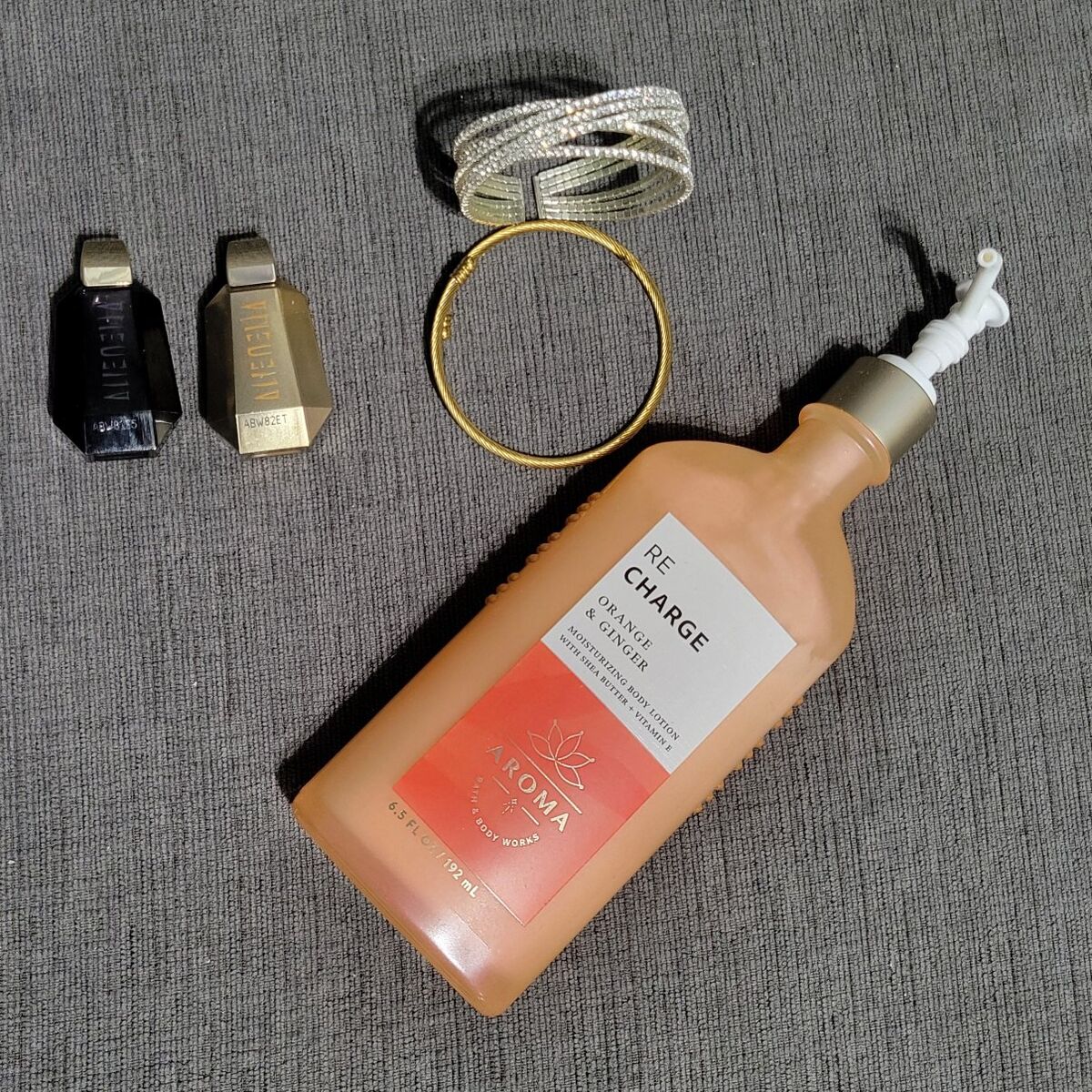 woman's real perfume, lotion, and bands