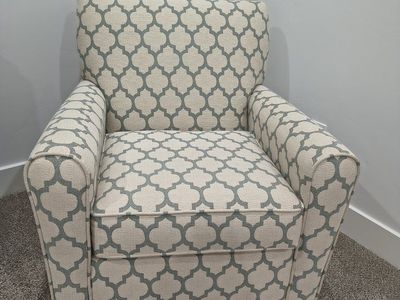 Patterned Upholstered Swivel Rocker in Beige and Muted Green