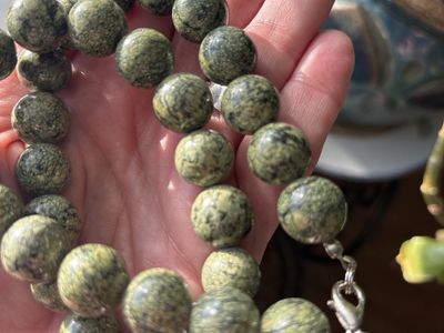 These beads are made of natural Serpentine, specifically a variety commonly marketed as Russian Serpentine.