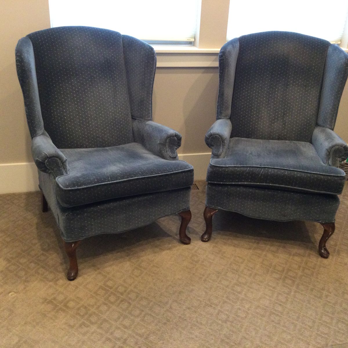 Two blue upholstered wing tip chairs