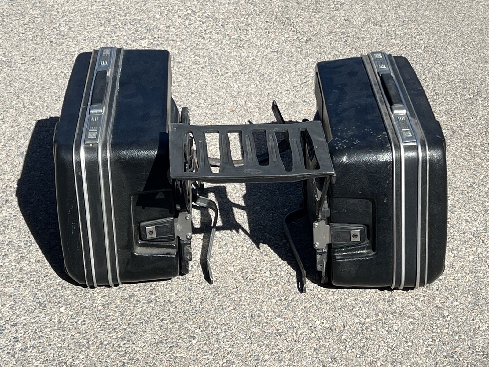 Universal motorcycle hard luggage saddlebags with mounting rack.