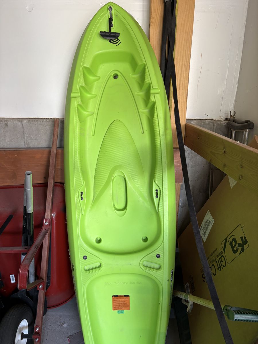 6.5 foot Emotion Kayak and paddle.