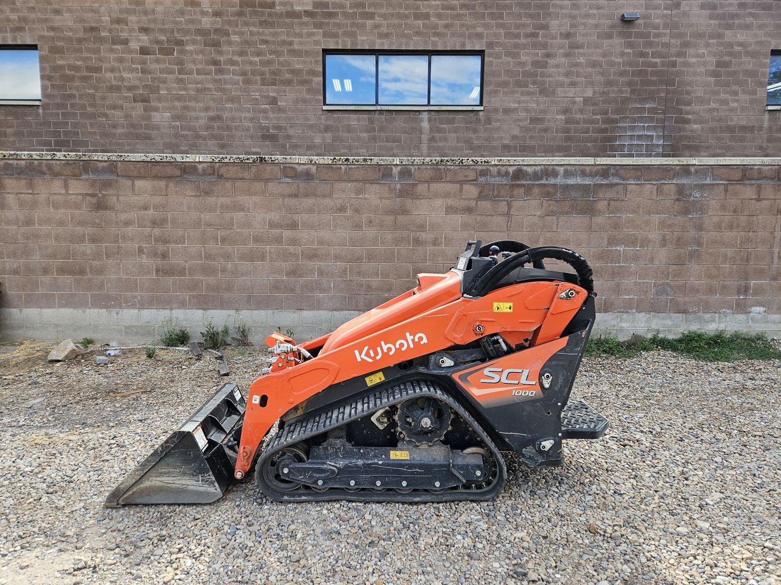 Kubota SCL1000 Stand-On Track Loader - Compact & Powerful Excavator