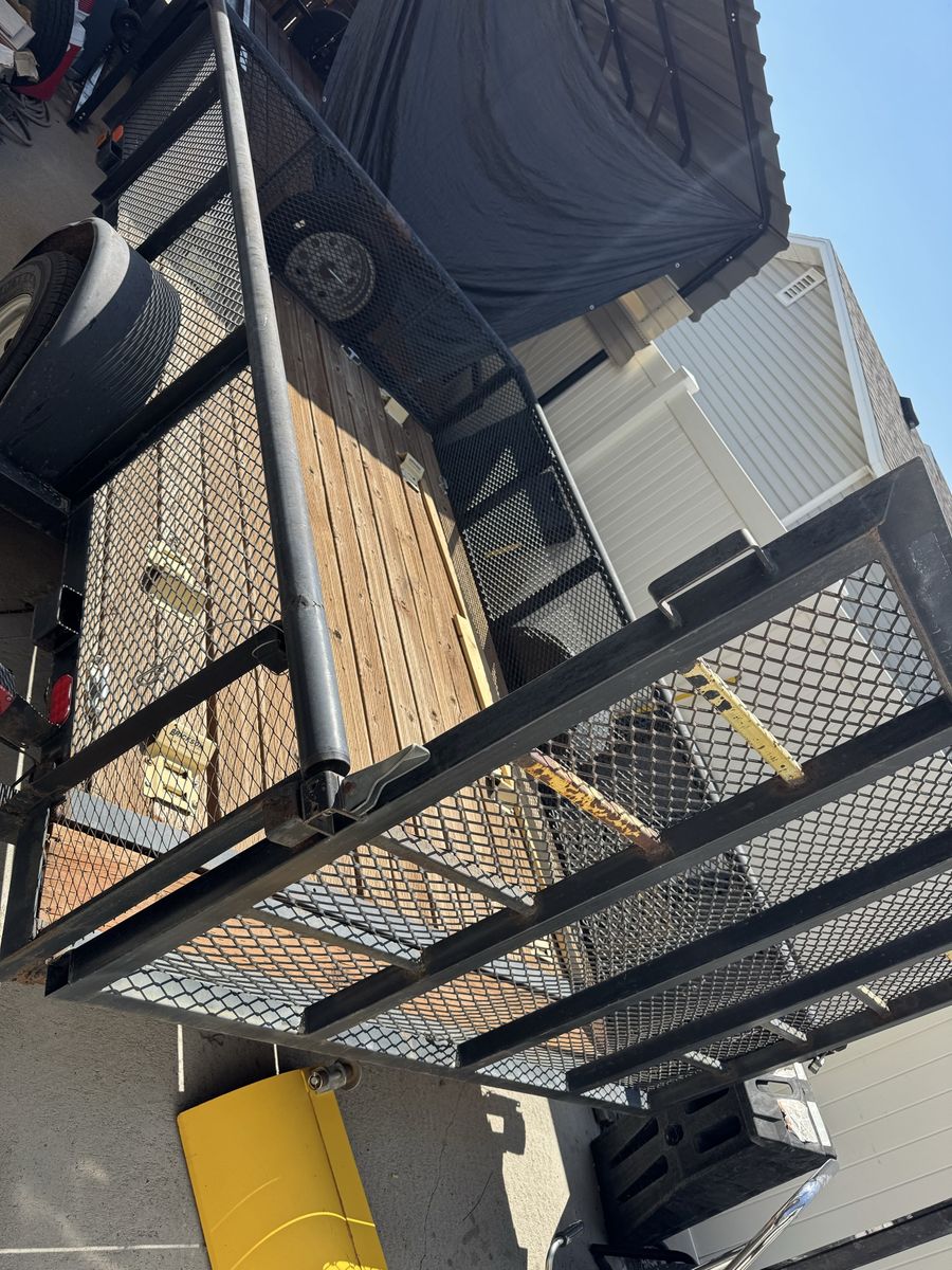 11 foot Single Axle Utility Trailer with Wood Deck and Mesh Ramp Gate.