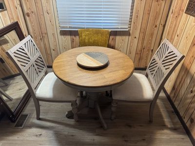 Round Pedestal Dining Table with Two Upholstered Chairs