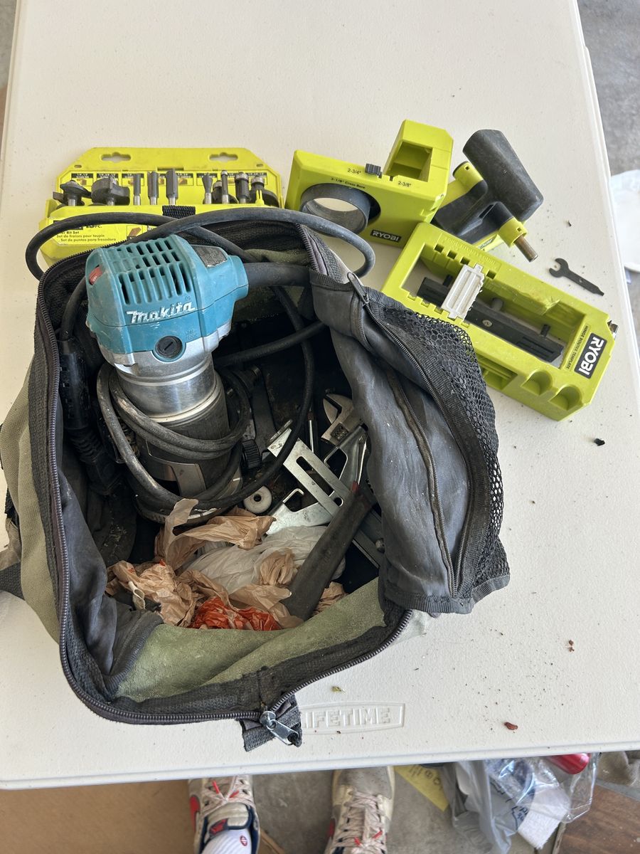 Bag with Makita Router and Ryobi accessories.