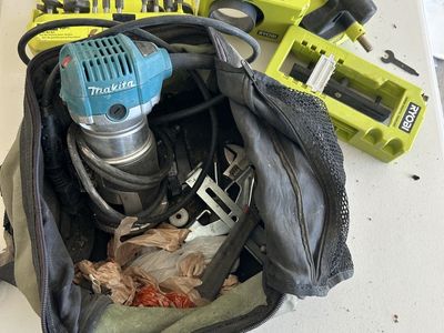 Bag with Makita Router and Ryobi accessories.
