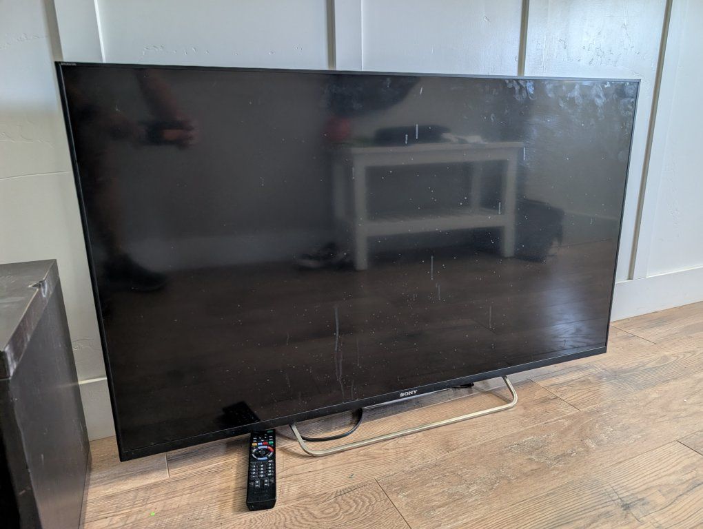 Sony Bravia Smart TV, 50-inch, Black with Remote, Power Cable, and universal VESA mount adapter.