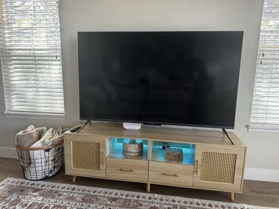 Natural wood TV stand with rattan doors