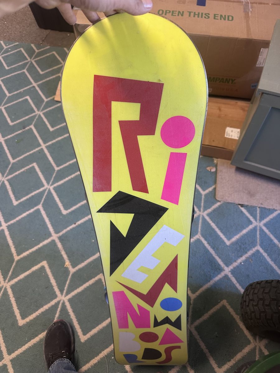 Kids ride snowboard