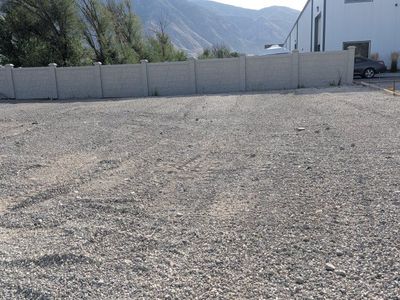 Semi truck parking gravel yard.