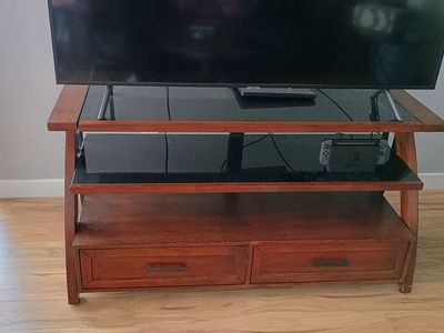 Wooden TV Stand with Black Glass Shelves and Storage Drawers