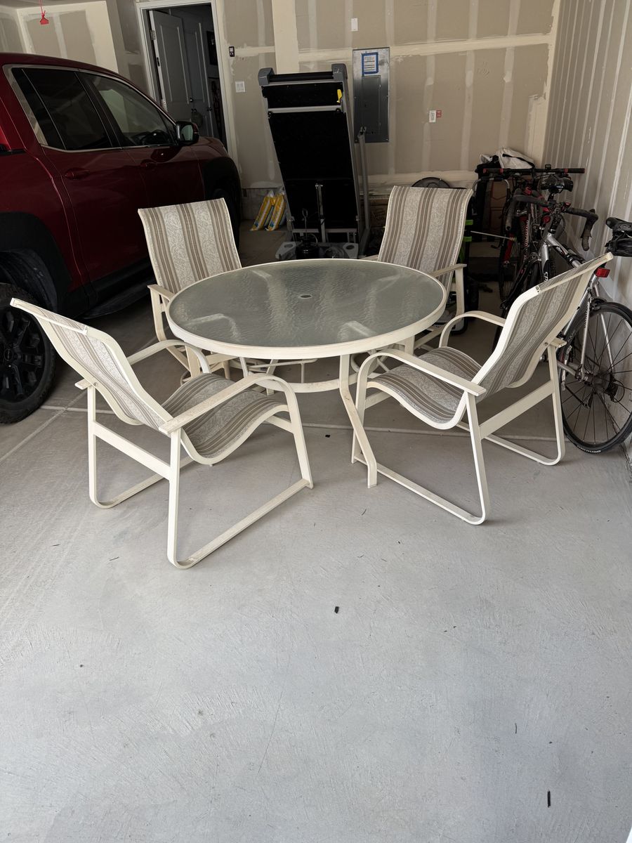 Four Lawn Chairs and Round Table