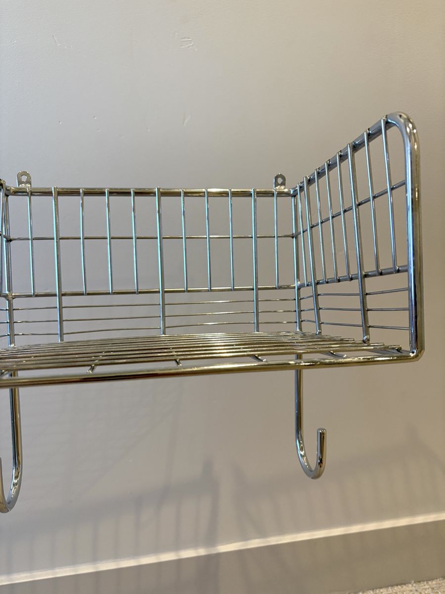Wall mount ironing board hanger with basket