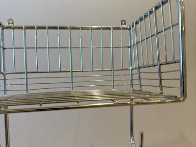 Wall mount ironing board hanger with basket
