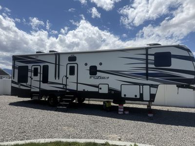 Keystone Fuzion RV Toy Hauler Travel Trailer - Spacious, Full Kitchen, AC, Awnings