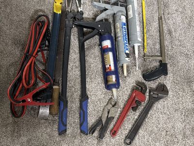 Mixed Tool Lot: Bolt Cutters, Caulking Guns, Wrenches, Jumper Cables, Saw, Pry Bars
