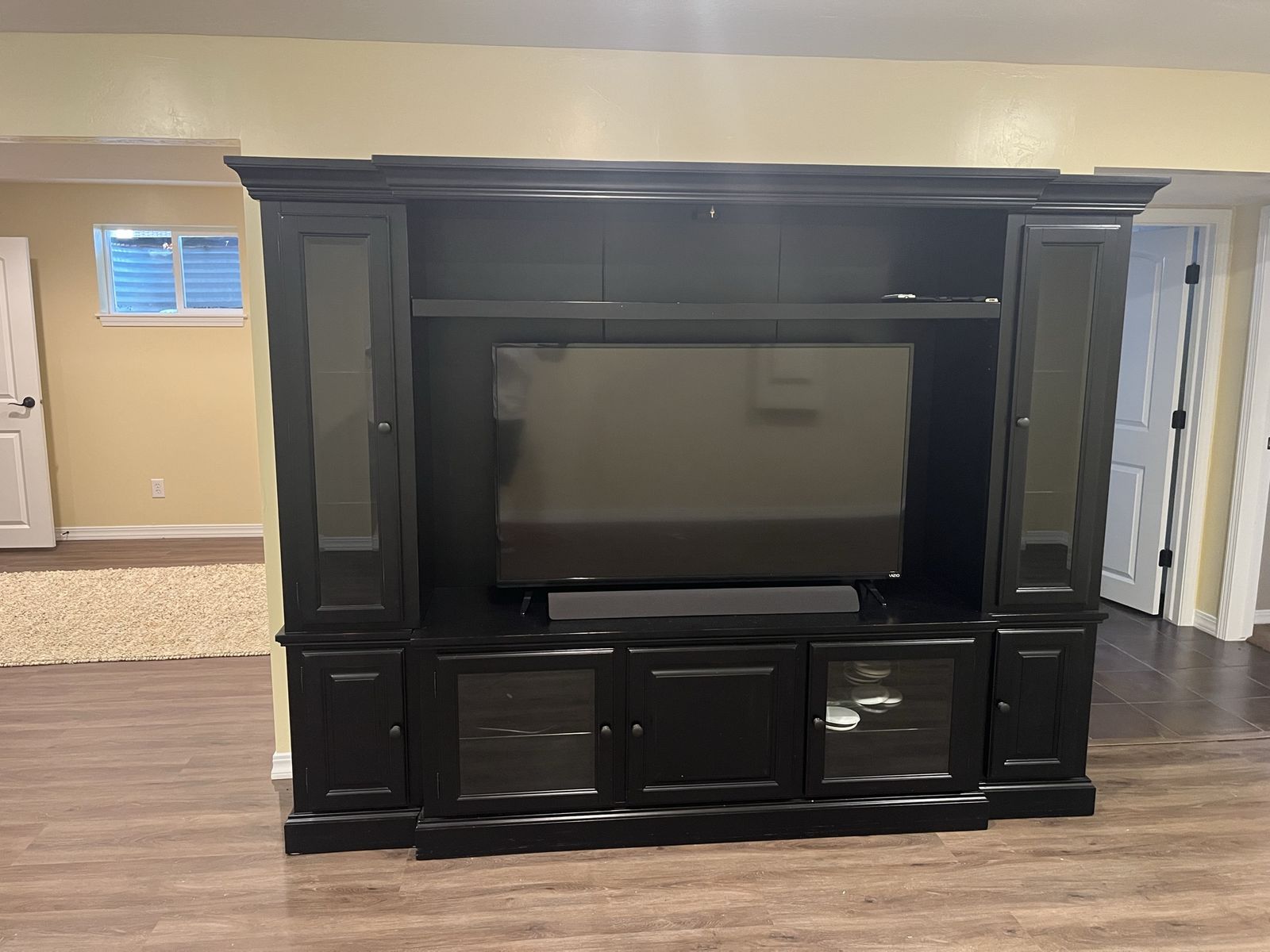 Large Black Wooden Entertainment Center TV Stand and TV with Glass Doors and Shelves