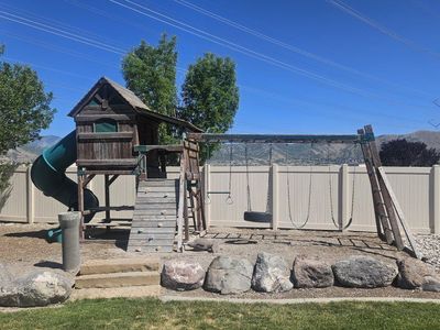 Free - Large Wooden Playset with Slide, Swings, Monkey Bars, and Climbing Wall - Backyard Fun