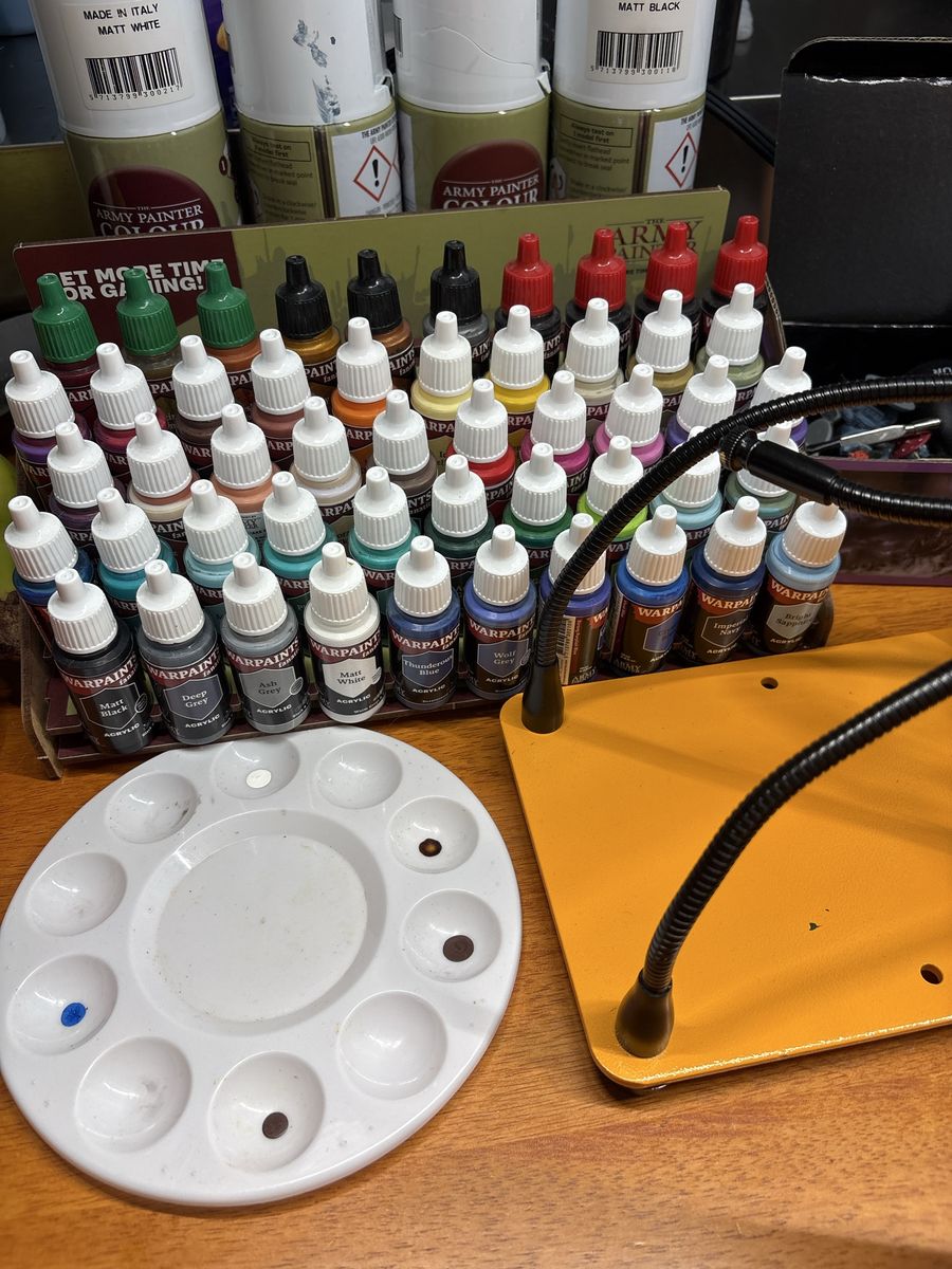 Army painter paint set with 4 primer colors, an assortment of brushes, a gripper stand and about 100 miniatures.