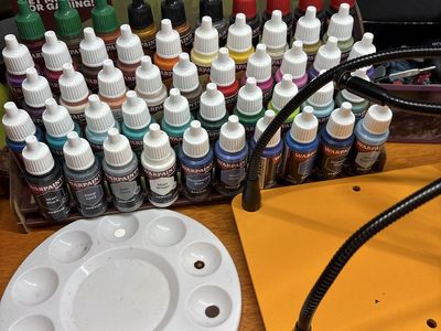 Army painter paint set with 4 primer colors, an assortment of brushes, a gripper stand and about 100 miniatures.