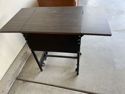 Folding Craft Table with Wheels - Dark Wood Finish, Black Frame, Space-Saving Design