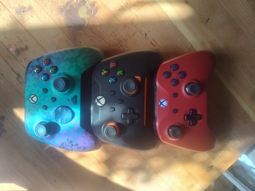3 Xbox controllers one is a rematch