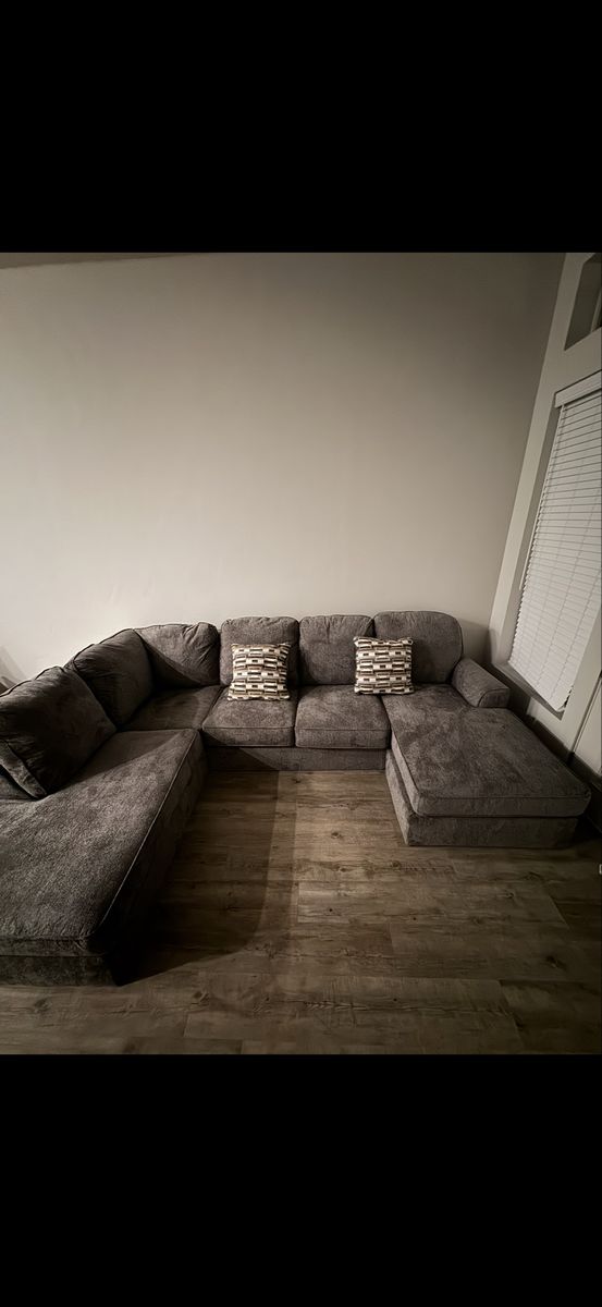 Large Gray U-Shaped Sectional Sofa with Throw Pillows