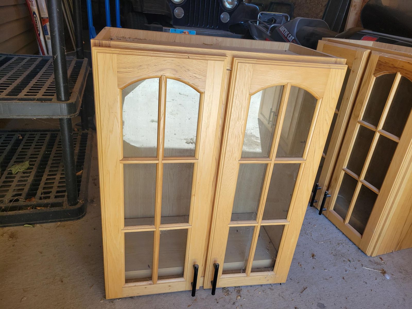 Pair of Light Wood Kitchen Wall Cabinets with Glass Arch Top Doors & Black Handles